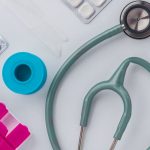 Overhead shot of medical supplies including stethoscope, pills, and scissors. — Dr. Kerry Evans and the Continuous Evolution