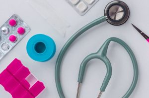 Overhead shot of medical supplies including stethoscope, pills, and scissors. — Dr. Kerry Evans and the Continuous Evolution