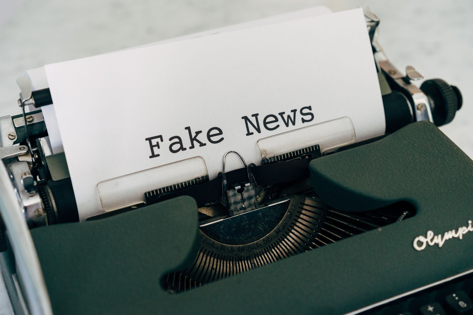 Close-up of vintage typewriter printing 'Fake News', depicting false information concepts. — How Rayo Vallecano Stands Out in