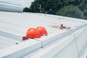 Red hard hats and safety equipment on a metal roof, emphasizing construction safety. — Pannelling Creates a Stylish and Timel