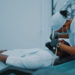 A dental professional performs a procedure on a patient in a Lagos clinic. — Purchase Testosterone Injections with Medical Gu