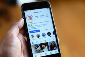 Close-up of a smartphone displaying an Instagram profile screen. — Secrets Revealed: White Label Facebook Ad Tactics That Con