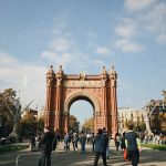 People walking near Arc de Triomf in Barcelona with clear skies overhead. — Walking with Legends Gokyo and EBC with Sherpa Gu