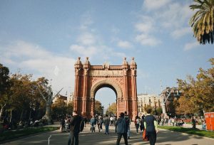 People walking near Arc de Triomf in Barcelona with clear skies overhead. — Walking with Legends Gokyo and EBC with Sherpa Gu