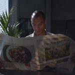 Businessman focused on reading newspaper in a sunny indoor office setting. — What Should I Know About Getting a Roof Inspecti