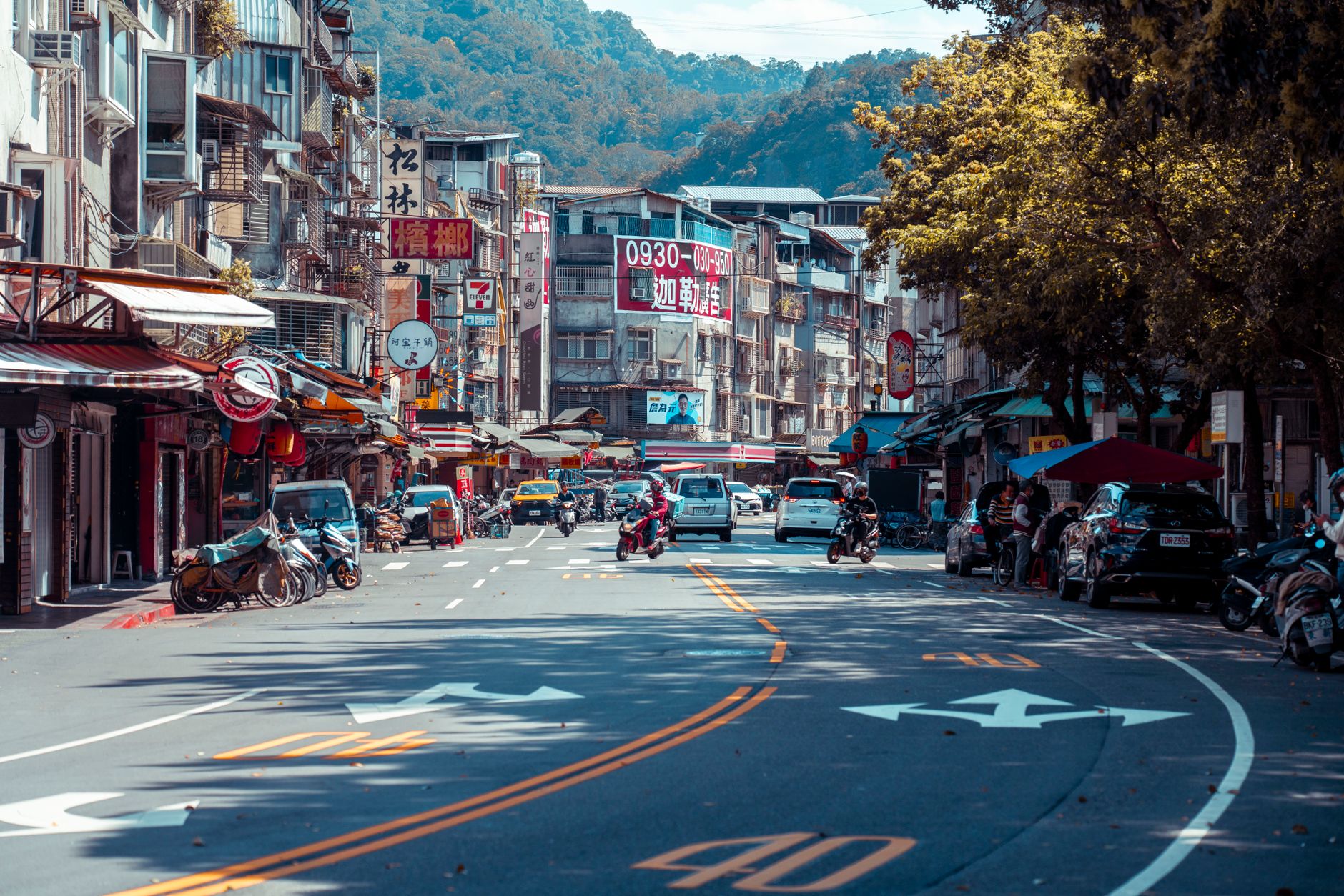 Vibrant urban street scene with shops, vehicles, and mountains in an Asian city. — Why a Well-Structured Eviction Notice Main